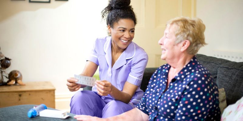 care worker with a resident in a care home